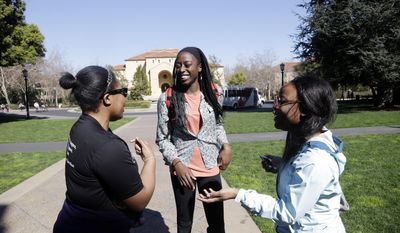 ADVANCE FOR WEEKEND EDITIONS, FEB. 22-23 - In this Feb. 19, 2014 photo, Chiney Ogwumike, a member of Stanford's NCAA college basketball team, center, talks to Lola Oyetuga, at left, and Constance Hosannah, two high school students considering Stanford, on the university's campus in Stanford, Calif. (AP Photo/Marcio Jose Sanchez)