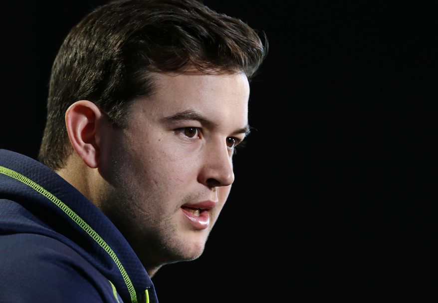 Alabama quarterback AJ McCarron answers a question during a news conference at the NFL football scouting combine in Indianapolis, Friday, Feb. 21, 2014. (AP Photo/Michael Conroy)
