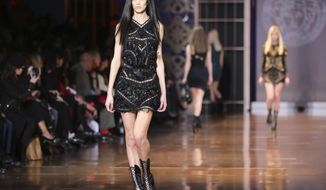 Models wear creations for Versace women&#39;s Fall-Winter 2014-15 collection, part of the Milan Fashion Week, unveiled in Milan, Italy, Friday, Feb. 21, 2014. (AP Photo/Antonio Calanni)