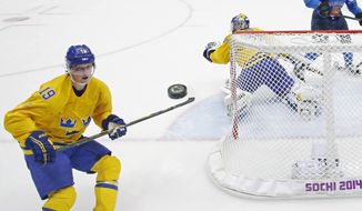 Sweden forward Nicklas Backstrom watches a shot that got past Sweden goaltender Henrik Lundqvist during a men&#39;s semifinal ice hockey game against Finland at the 2014 Winter Olympics, Friday, Feb. 21, 2014, in Sochi, Russia. (AP Photo/David J. Phillip)