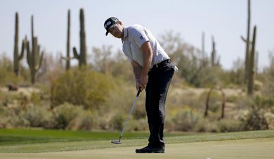 Hunter Mahan putts on the 10th hole in his second-round match against Richard Sterne, of South Africa, at the Match Play Championship golf tournament Thursday, Feb. 20, 2014, in Marana, Ariz. (AP Photo/Matt York)