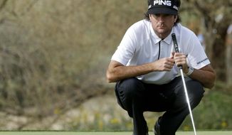 Bubba Watson lines up a putt on the 16th hole in his third-round match against Victor Dubuisson, of France, during the third round of the Match Play Championship golf tournament on Friday, Feb. 21, 2014, in Marana, Ariz. Dubuisson won 1-up. (AP Photo/Ted S. Warren)