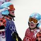 Canada&#39;s Marielle Thompson, left, celebrates after winning the gold medal ahead of silver medalist and compatriot Kelsey Serwa, right, in the women&#39;s ski cross final at the Rosa Khutor Extreme Park, at the 2014 Winter Olympics, Friday, Feb. 21, 2014, in Krasnaya Polyana, Russia. (AP Photo/Andy Wong)