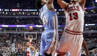 Chicago Bulls center Joakim Noah (13) shoots over Denver Nuggets forward Wilson Chandler (21) during the first half of an NBA basketball game Friday, Feb. 21, 2014, in Chicago. (AP Photo/Charles Rex Arbogast)