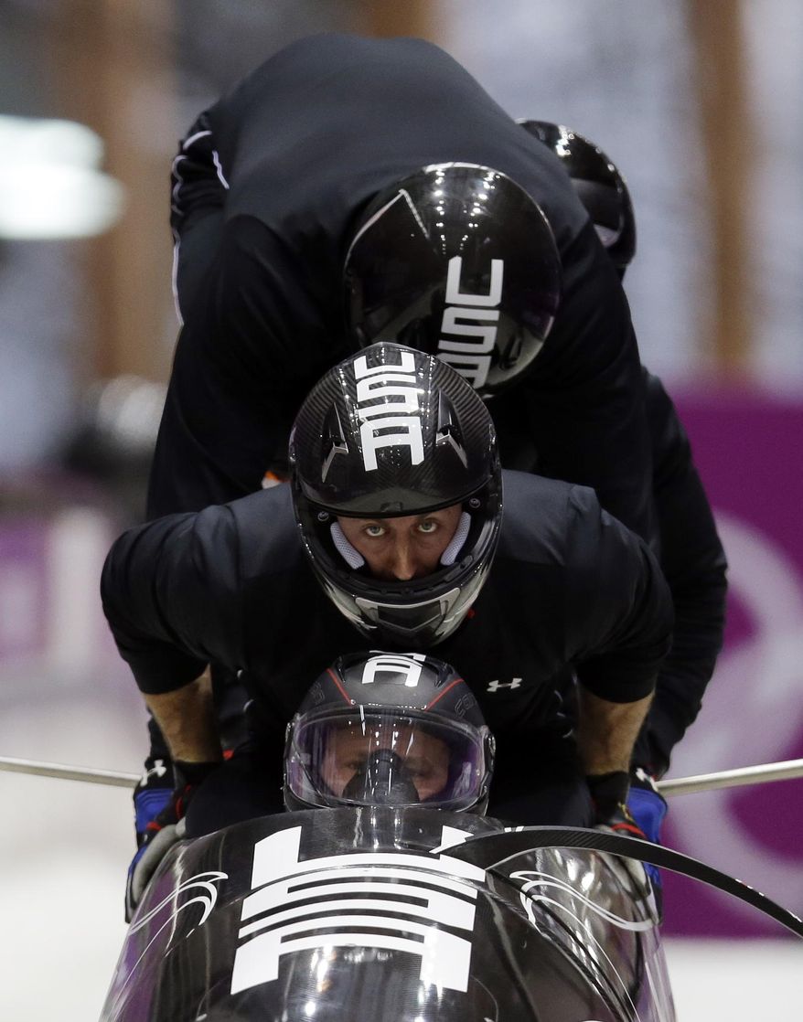 The team from the United States USA-1, piloted by Steven Holcomb, start a run during the men's four-man bobsled training at the 2014 Winter Olympics, Friday, Feb. 21, 2014, in Krasnaya Polyana, Russia. (AP Photo/Dita Alangkara)