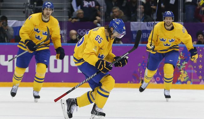 Sweden defenseman Erik Karlsson reacts after scoring a goal against Finland during the second period of a men&#x27;s semifinal ice hockey game at the 2014 Winter Olympics, Friday, Feb. 21, 2014, in Sochi, Russia. (AP Photo/Petr David Josek)