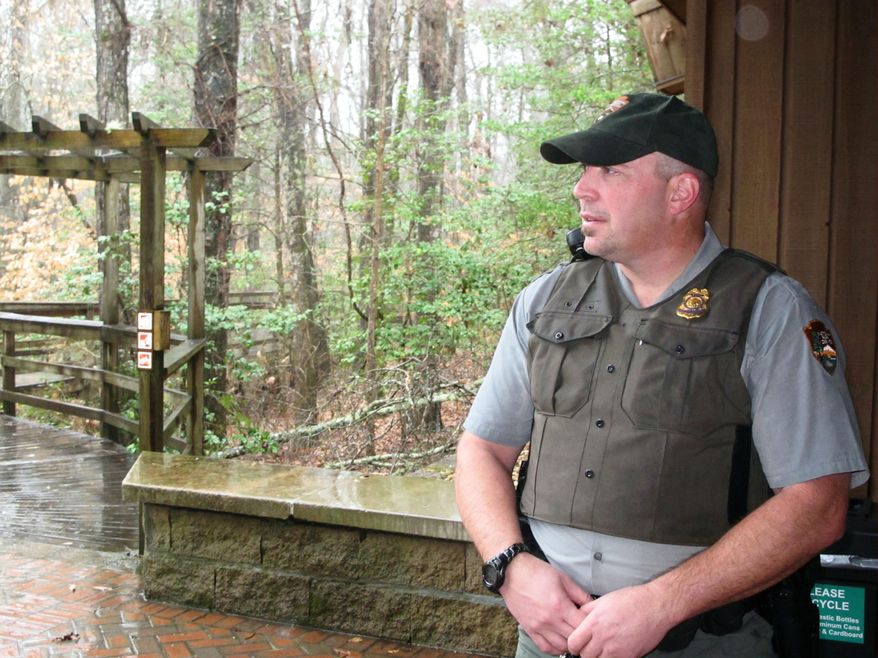 Chief Ranger Duane Michael surveys the Congaree National Park near Columbia, S.C., on Friday, Feb. 21, 2013. It took Michael and another ranger an entire day to cut a path through fallen trees and limbs into the park following an ice storm Feb. 11-13. The storm, the worst in South Carolina in a decade, caused widespread damage at the park, the only national park in the state, and has closed sections of the park's popular boardwalk. (AP Photo/Bruce Smith)
