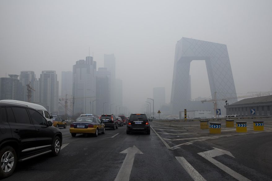 Cars clog in the traffic in Beijing's Central Business District on a hazy day, Friday, Feb. 21, 2014. A rare air pollution alert issued Friday in Beijing prompted health advisories and bans on barbeques, fireworks and demolition work, but fell short of the strictest measures which would include ordering half the city’s cars off the streets. (AP Photo/Alexander F. Yuan)