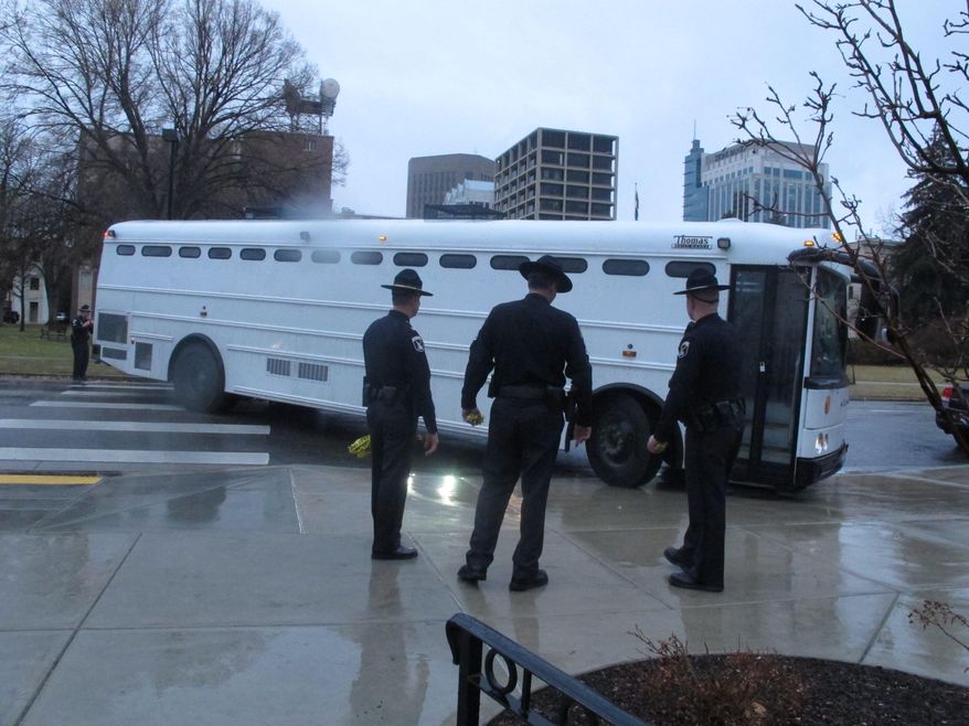 A law enforcement bus transports 25 gay rights protesters to jail on Thursday, Feb. 20, 2014 in Boise, Idaho, after they were arrested at the Capitol on charges of misdemeanor trespassing. The protesters, who blocked public access to the Idaho Senate for hours, were among 32 people arrested over the course of the day as they demanded a hearing for a measure to add discrimination protections for gays and lesbians to the Idaho Human Rights Act. (AP Photos/John Miller)