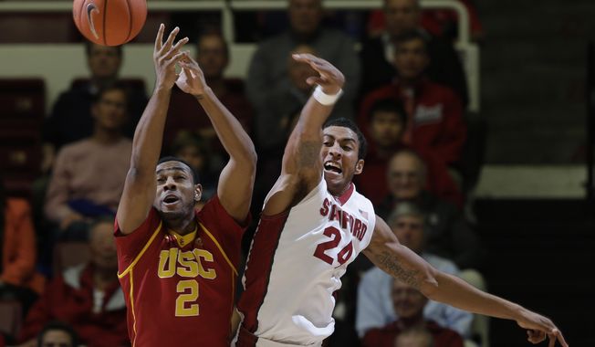 Southern California forward Roschon Prince (2) battles for a rebound against Stanford forward Josh Huestis (24) during the first half of an NCAA college basketball game on Thursday, Feb. 20, 2014, in Stanford, Calif. (AP Photo/Marcio Jose Sanchez)