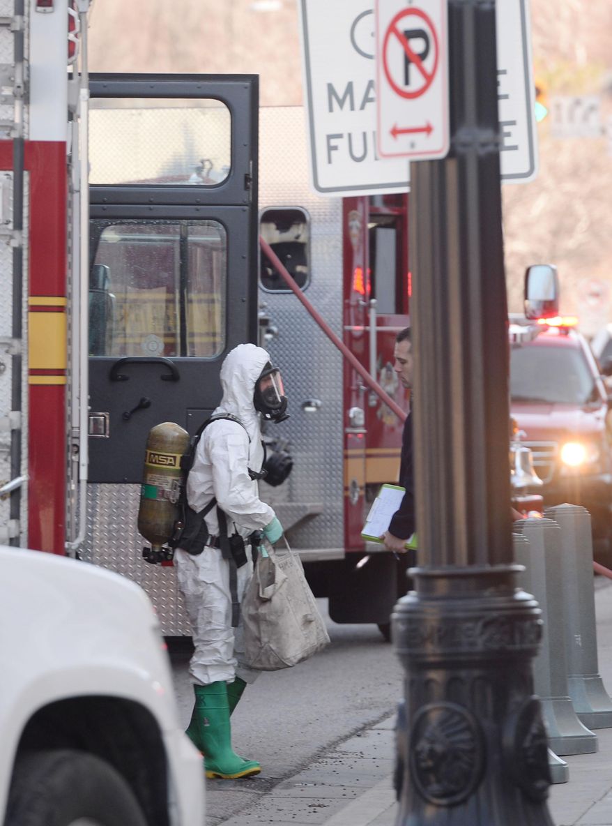 A Salt Lake City Fire Department HazMat Crew prepares to enter the Church of Jesus Christ of Latter-day Saints building in downtown Salt Lake City, Utah Friday, Feb. 21, 2014 after white powder was found in an envelope inside the building. Fire officials say four people who were exposed to the powder are being evaluated at a hospital. They were also put through a decontamination process. It's unclear if the powder is toxic. (AP Photo/The Salt Lake Tribune, Steve Griffin)
