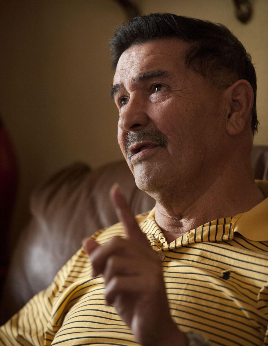Medal of Honor recipient Santiago Erevia, is photographed on Saturday, Feb. 22, 2014, at his home in San Antonio. Erevia is one of twenty-four army veterans who will receive the award following a congressionally mandated review conducted to ensure that eligible award recipients were not bypassed due to prejudice. (AP Photo/Darren Abate)