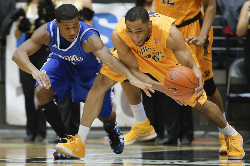 Wichita State's Tekele Cotton steals the ball from Drake's Richard Carter during the first half of an NCAA college basketball game Saturday, Feb. 22, 2014, at Koch Arena in Wichita, Kan. (AP Photo/The Wichita Eagle, Travis Heying)