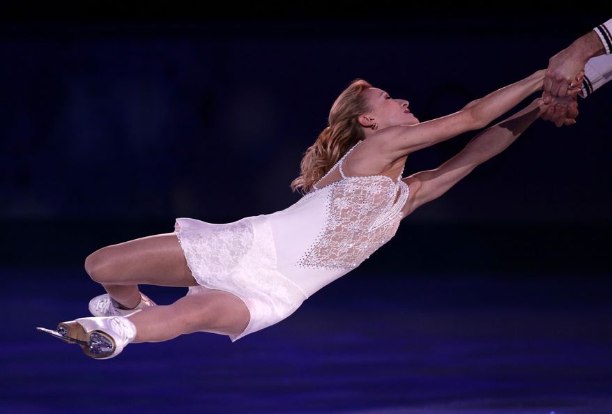 Tatiana Volosozhar and Maxim Trankov of Russia perform during the figure skating exhibition gala at the Iceberg Skating Palace during the 2014 Winter Olympics, Saturday, Feb. 22, 2014, in Sochi, Russia. (AP Photo/Bernat Armangue)