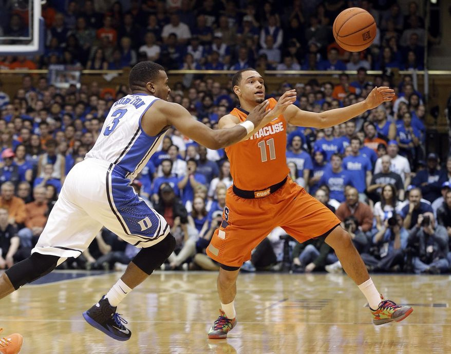 Duke's Tyler Thornton (3) and Syracuse's Tyler Ennis (11) chase the ball during the first half of an NCAA college basketball game in Durham, N.C., Saturday, Feb. 22, 2014. (AP Photo/Gerry Broome)