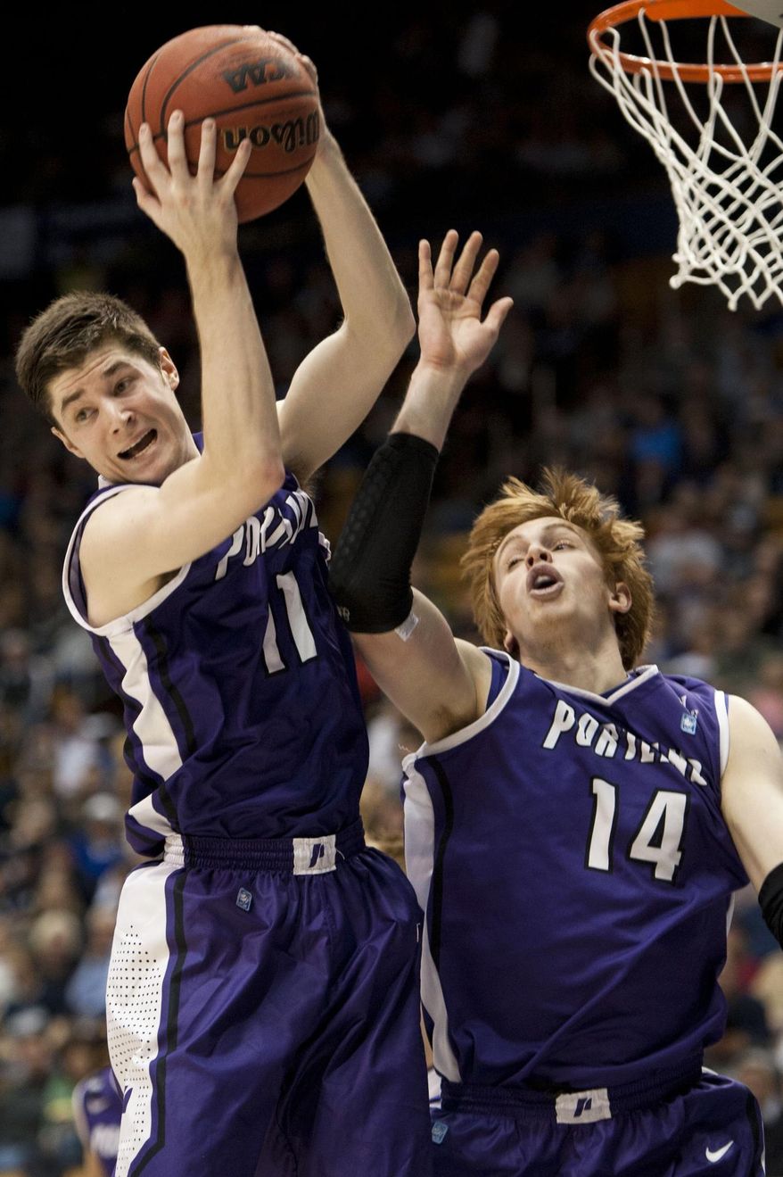 Portland's Bobby Sharp and Riley Barker grab a rebound against BYU during the first half of an NCAA college basketball game in Provo, Utah, Saturday, Feb. 22, 2014. (AP Photo/The Daily Herald, Grant Hindsley)