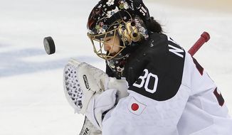 Goalkeeper Nana Fujimoto of Japan blocks a shot on goal during the second period of the 2014 Winter Olympics women&#39;s ice hockey game against Germany at Shayba Arena, Tuesday, Feb. 18, 2014, in Sochi, Russia. (AP Photo/Petr David Josek)
