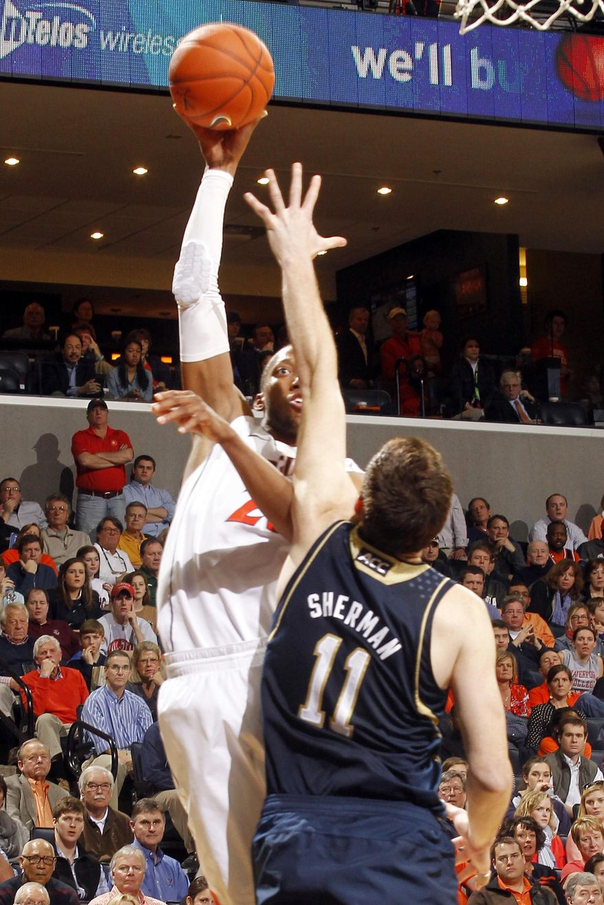 Virginia forward Akil Mitchell, left, shoots over Notre Dame center Garrick Sherman (11) during an NCAA college basketball game Saturday, Feb. 22, 2014, in Charlottesville, Va. Virginia won 70-49. (AP Photo/Andrew Shurtleff)