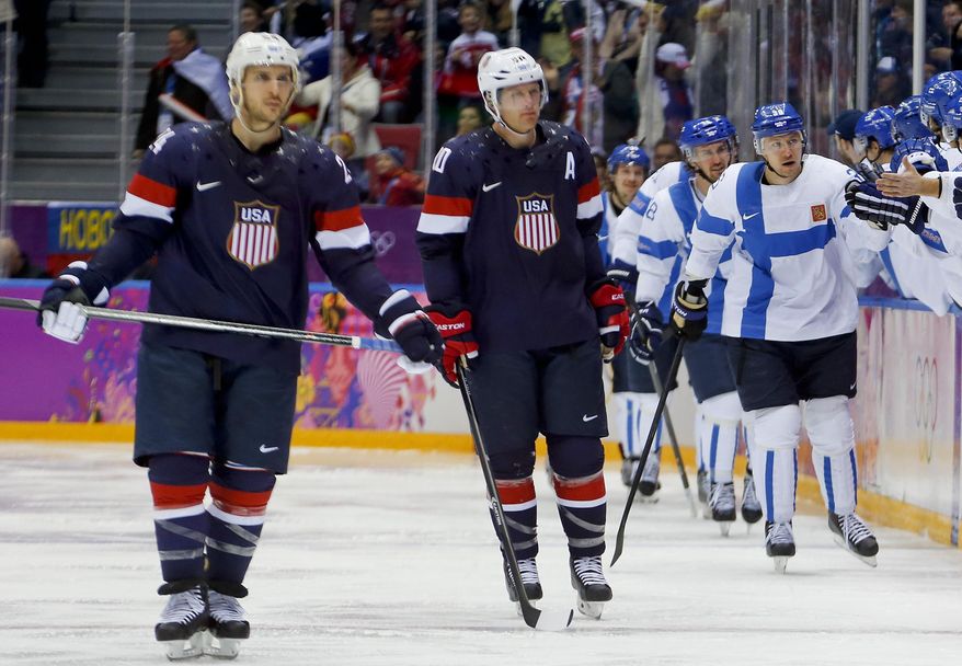 Team Finland celebrates a second period goal against the USA during the men's bronze medal ice hockey game at the 2014 Winter Olympics, Saturday, Feb. 22, 2014, in Sochi, Russia. (AP Photo/Petr David Josek)