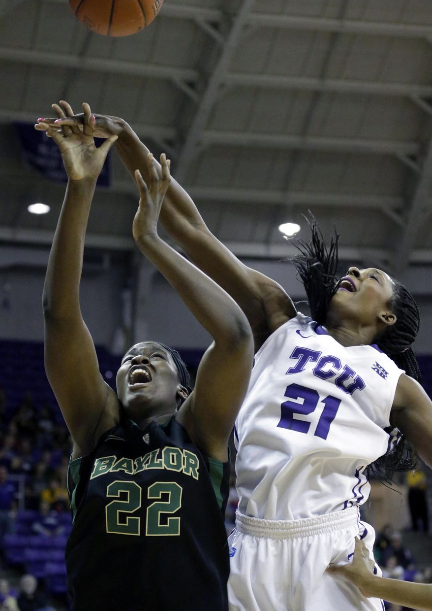Baylor center Sune Agbuke (22) and TCU center Latricia Lovings (21) jumps for the rebound during the first half of an NCAA college basketball game Saturday, Feb. 22, 2014, in Fort Worth, Texas. (AP Photo/LM Otero)