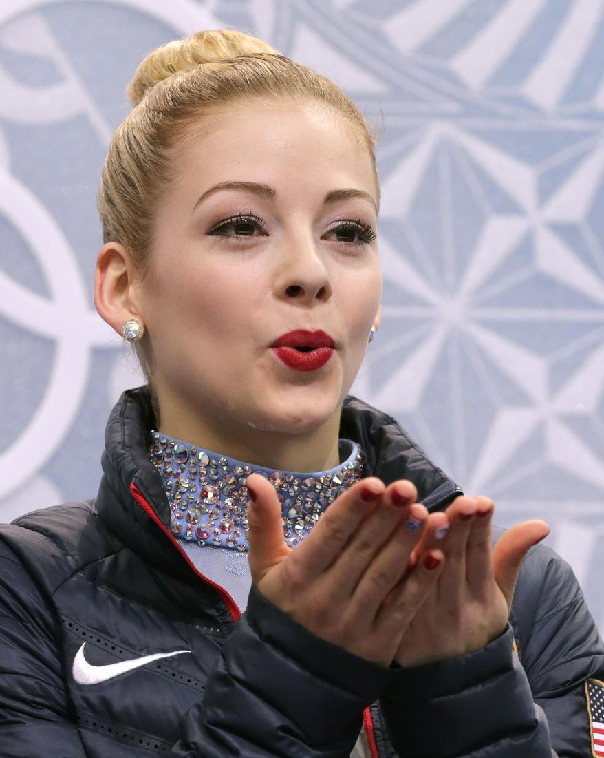 Gracie Gold of the United States blows a kiss to spectators as she waits in the results area after completing her routine in the women's free skate figure skating finals at the Iceberg Skating Palace during the 2014 Winter Olympics, Thursday, Feb. 20, 2014, in Sochi, Russia. (AP Photo/Bernat Armangue)