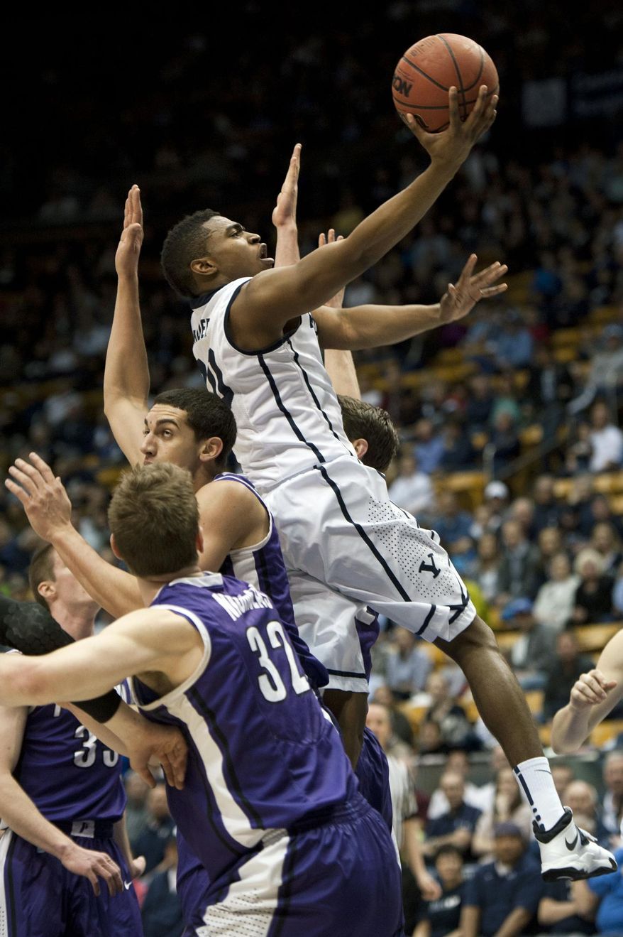 BYU's Anson Winder goes to the basket over Portland's defense during the first half of an NCAA college basketball game in Provo, Utah, Saturday, Feb. 22, 2014. (AP Photo/The Daily Herald, Grant Hindsley)