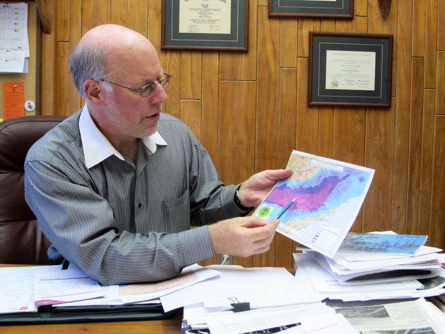 Tim Adams, the resource development division director for the South Carolina Forestry Commission, shows a map during an interview in his office in Columbia, S.C., on Thursday, Feb. 20, 2014. The map shows where snow and rain affected South Carolina earlier this month during the worst winter storm to hit the state in a decade. (AP Photo/Bruce Smith)