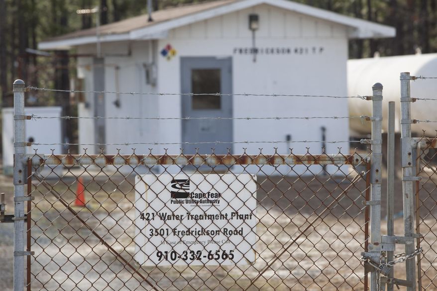 Photo shows the small well water treatment plant that services the neighbors of the Flemington Road community located in Wilmington, N.C.,, on Wednesday, Feb. 19, 2014. The facility is located nearby the L.V. Sutton Complex operated by Duke Energy just outside of Wilmington. Members of the community feel the plant could be polluting well water with spill off and seepage from large coal ash ponds nearby the treatment plant. (AP Photo/Randall Hill)