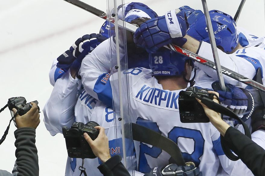 Team Finland celebrates Teemu Selanne's goal against the United States during the second period of the men's bronze medal ice hockey game at the 2014 Winter Olympics, Saturday, Feb. 22, 2014, in Sochi, Russia. (AP Photo/Matt Slocum)