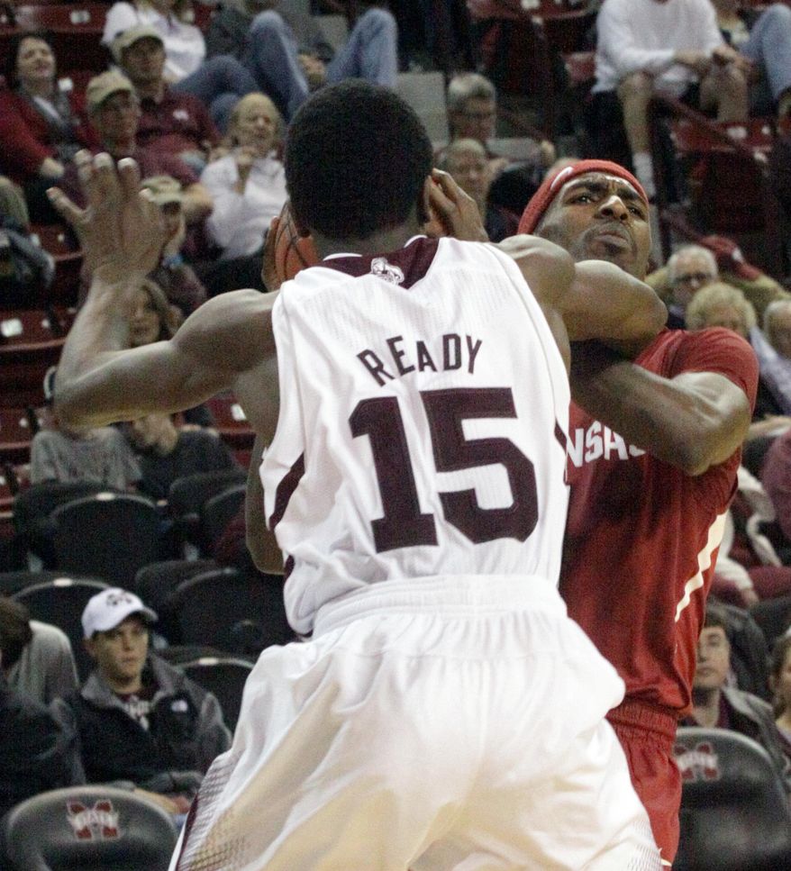 Mississippi State's I.J. Ready (15) fouls Arkansas' Mardracus Wade, right, during the second half of an NCAA college basketball game in Starkville, Miss., Saturday, Feb. 22, 2014. Arkansas won 73-69 (AP Photo/Jim Lytle)