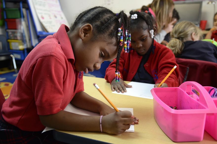 In this photo from Feb. 6, 2014, kindergarten students Jaielle McCane, left, and Jacques Smith work on an assignment at the Chattanooga Charter School for Excellence at the Eastgate Town Center. (AP Photo/Chattanooga Times Free Press, John Rawlston) THE DAILY CITIZEN OUT; NOOGA.COM OUT; CLEVELAND DAILY BANNER OUT; LOCAL INTERNET OUT.