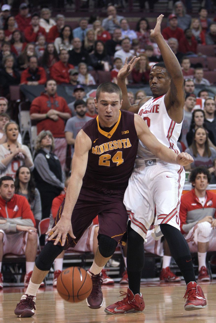 Minnesota's Joey King, left, drives the baseline past Ohio State's Lenzelle Smith during the first half of an NCAA college basketball game Saturday, Feb. 22, 2014, in Columbus, Ohio. (AP Photo/Jay LaPrete)