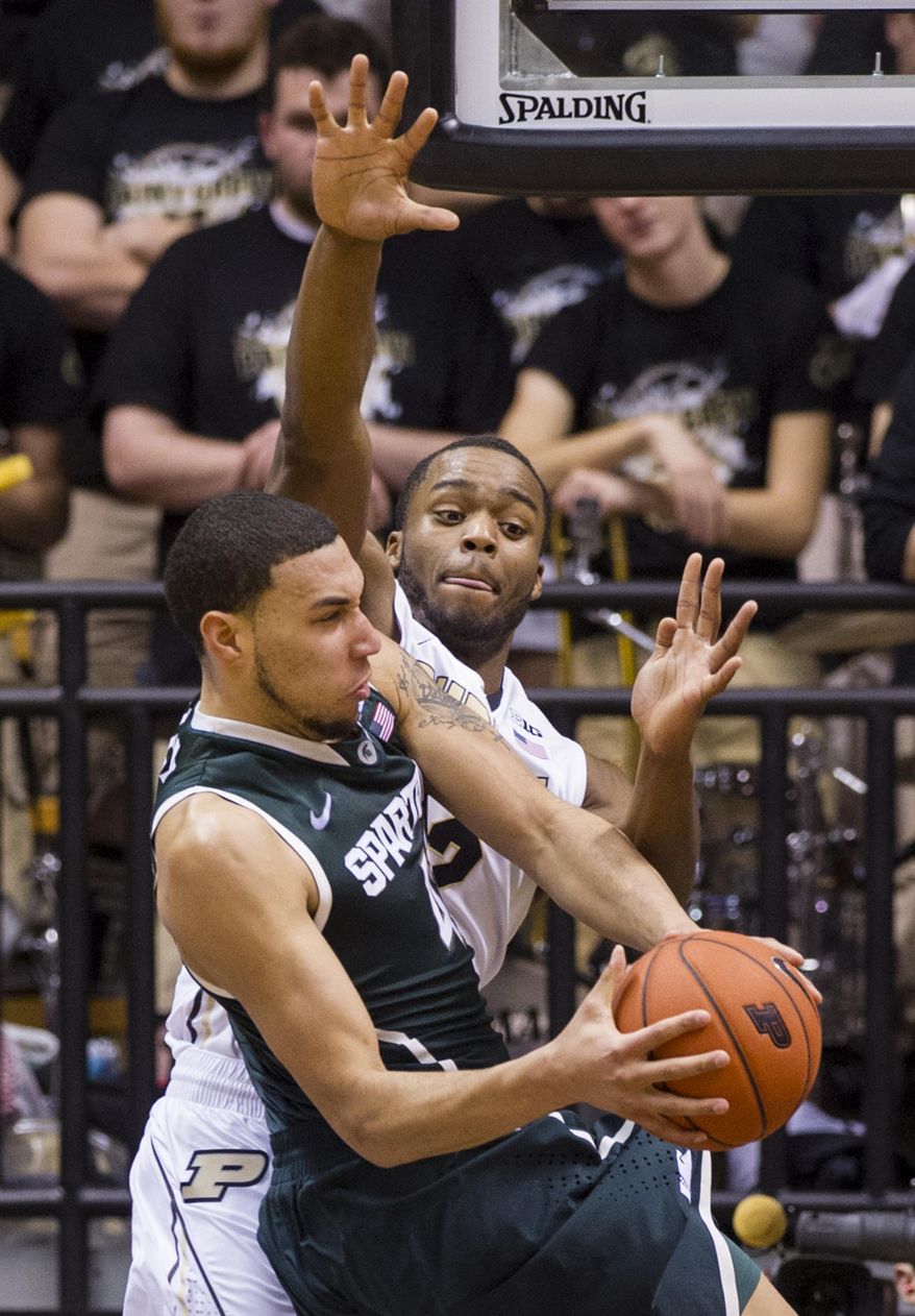Purdue’s Errick Peck (32) goes up in an attempt to block the shot of Michigan State’s Denzel Valentine (45) in the second half of an NCAA college basketball game, Thursday, Feb. 20, 2014, in West Lafayette, Ind. Michigan State defeated Purdue 94-79. (AP Photo/Doug McSchooler)