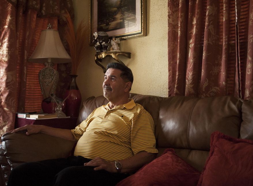 Medal of Honor recipient Santiago Erevia, is photographed on Saturday, Feb. 22, 2014, at his home in San Antonio. Erevia is one of twenty-four army veterans who will receive the award following a congressionally mandated review conducted to ensure that eligible award recipients were not bypassed due to prejudice. (AP Photo/Darren Abate)