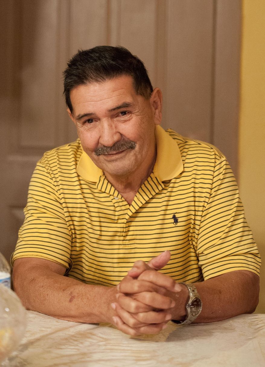 Medal of Honor recipient Santiago Erevia, is photographed on Saturday, Feb. 22, 2014, at his home in San Antonio, Texas. Erevia is one of twenty-four army veterans who will receive the award following a congressionally mandated review conducted to ensure that eligible award recipients were not bypassed due to prejudice. (AP Photo/Darren Abate)