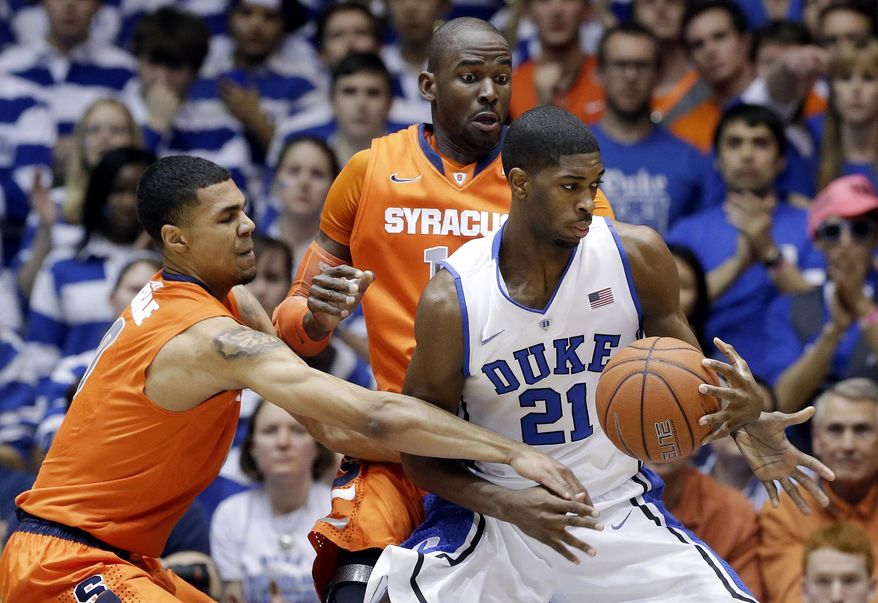 Duke's Amile Jefferson (21) is guarded by Syracuse's Michael Gbinije, left, and Baye-Moussa Keita during the first half of an NCAA college basketball game in Durham, N.C., Saturday, Feb. 22, 2014. (AP Photo/Gerry Broome)