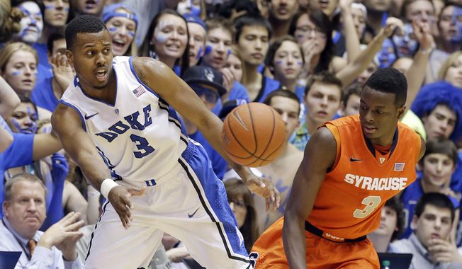 Duke&#x27;s Tyler Thornton (3) saves the ball from out of bounds as Syracuse&#x27;s Jerami Grant (3) stands near during the second half of an NCAA college basketball game in Durham, N.C., Saturday, Feb. 22, 2014. Duke won 66-60. (AP Photo/Gerry Broome)
