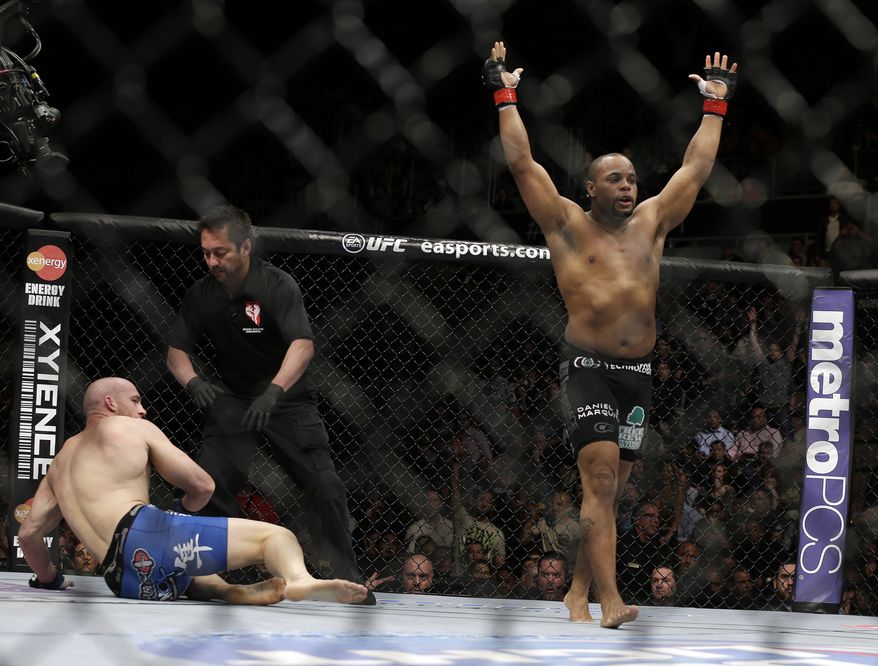 Daniel Cormier, right, reacts as the referee stops his UFC 170 mixed martial arts light heavyweight fight against Patrick Cummins on Saturday, Feb. 22, 2014, in Las Vegas. (AP Photo/Isaac Brekken)