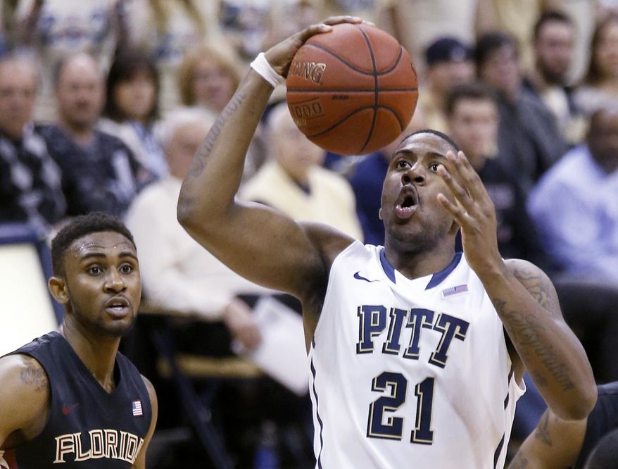 Pittsburgh's Lamar Patterson (21) shoots in front of Florida State's Ian Miller, left, during the first half of an NCAA college basketball game, Sunday, Feb. 23, 2014, in Pittsburgh. (AP Photo/Keith Srakocic)