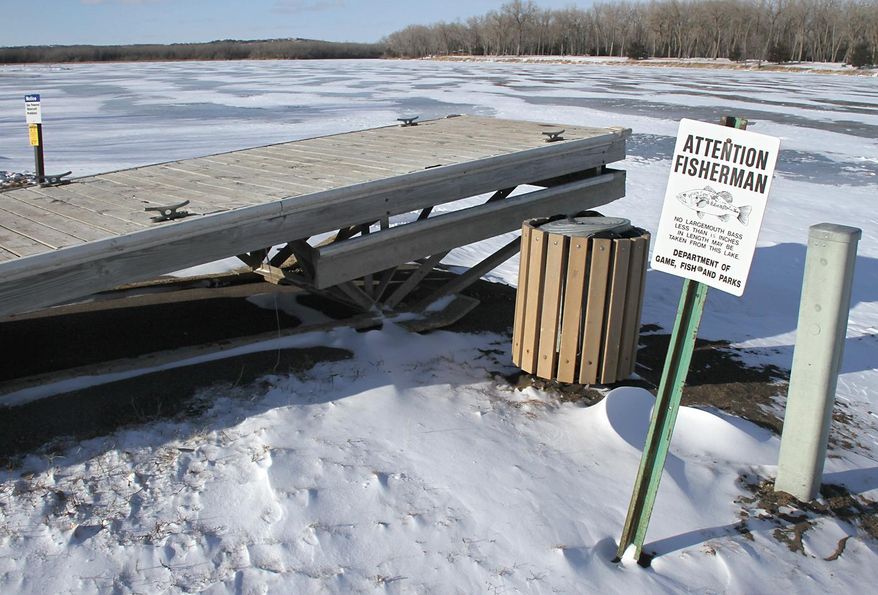 FOR RELEASE MONDAY, FEBRUARY 24, 2014, AT 1:01 A.M. CST - In this Feb. 6, 2014 photo, a warning sign for fisherman is posted along Lank Yankton in Yankton, S.D. Plans are slowly progressing on a solution to the growth in invasive fish species in Lake Yankton. However, Nebraska Game & Parks Commission fisheries biologist Jeff Schuckman said there is a long way to go before tackling the proposed "chemical renovation," a process that involves partial draining the lake and introducing a chemical meant to kill off the fish in the lake. (AP Photo/Yankton Press & Dakotan, Kelly Hertz)