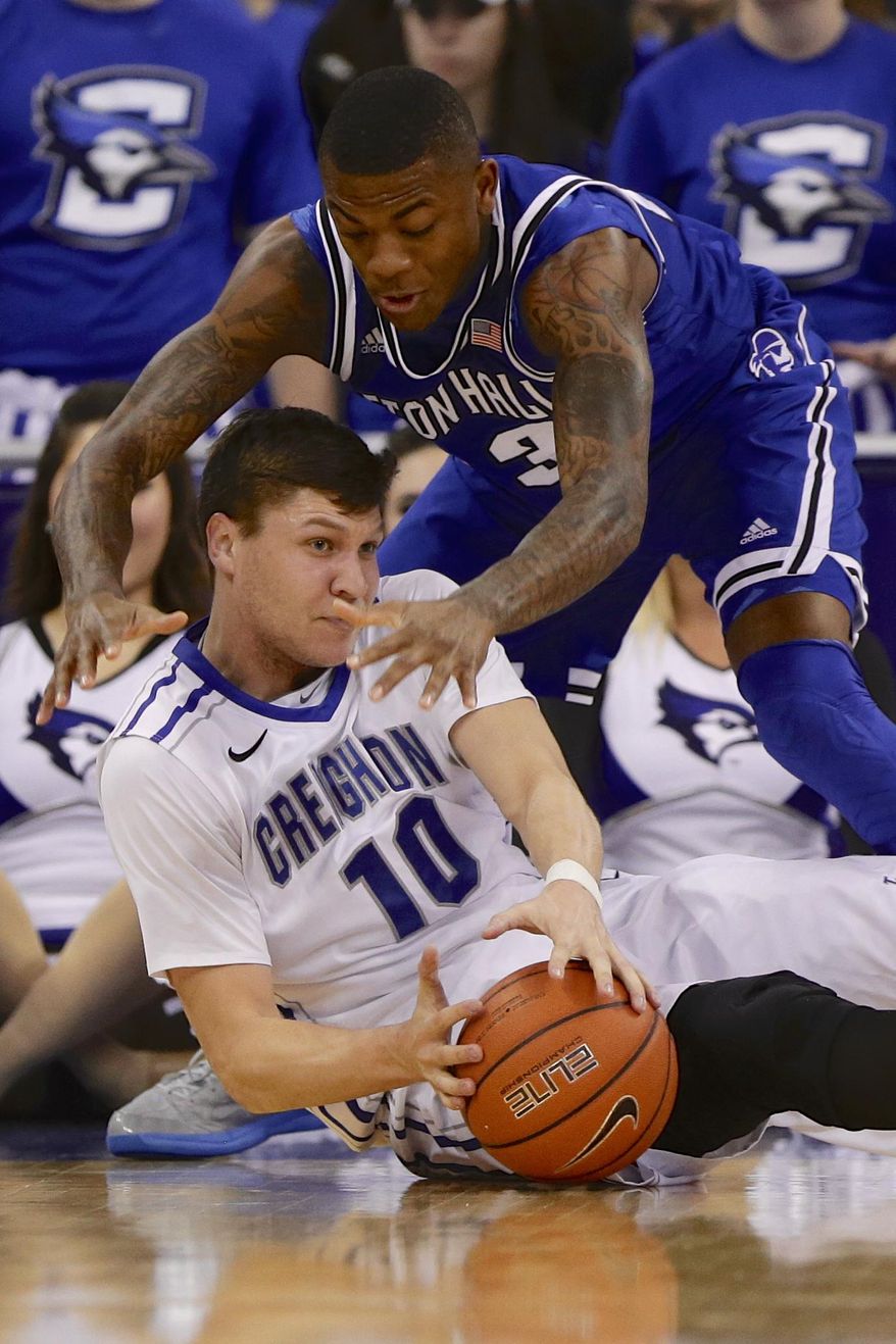 Creighton's Grant Gibbs (10) and Seton Hall's Fuquan Edwin, top, go for a loose ball in the first half of an NCAA college basketball game in Omaha, Neb., Sunday, Feb. 23, 2014. (AP Photo/Nati Harnik)