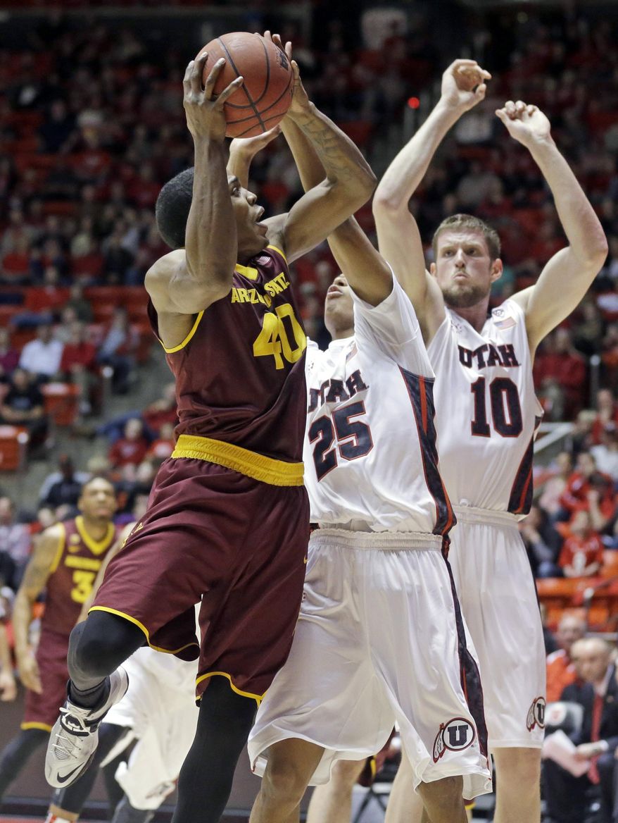 Arizona State's Shaquielle McKissic (40) goes to the basket as Utah's Kenneth Ogbe (25) and teammate Renan Lenz (10) defend in the first half of an NCAA college basketball game Sunday, Feb. 23, 2014, in Salt Lake City. (AP Photo/Rick Bowmer)