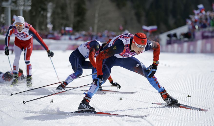 Russia's Alexander Legkov crosses the finish to win the gold medal in the men's 50K cross-country race at the 2014 Winter Olympics, Sunday, Feb. 23, 2014, in Krasnaya Polyana, Russia. (AP Photo/Gregorio Borgia)