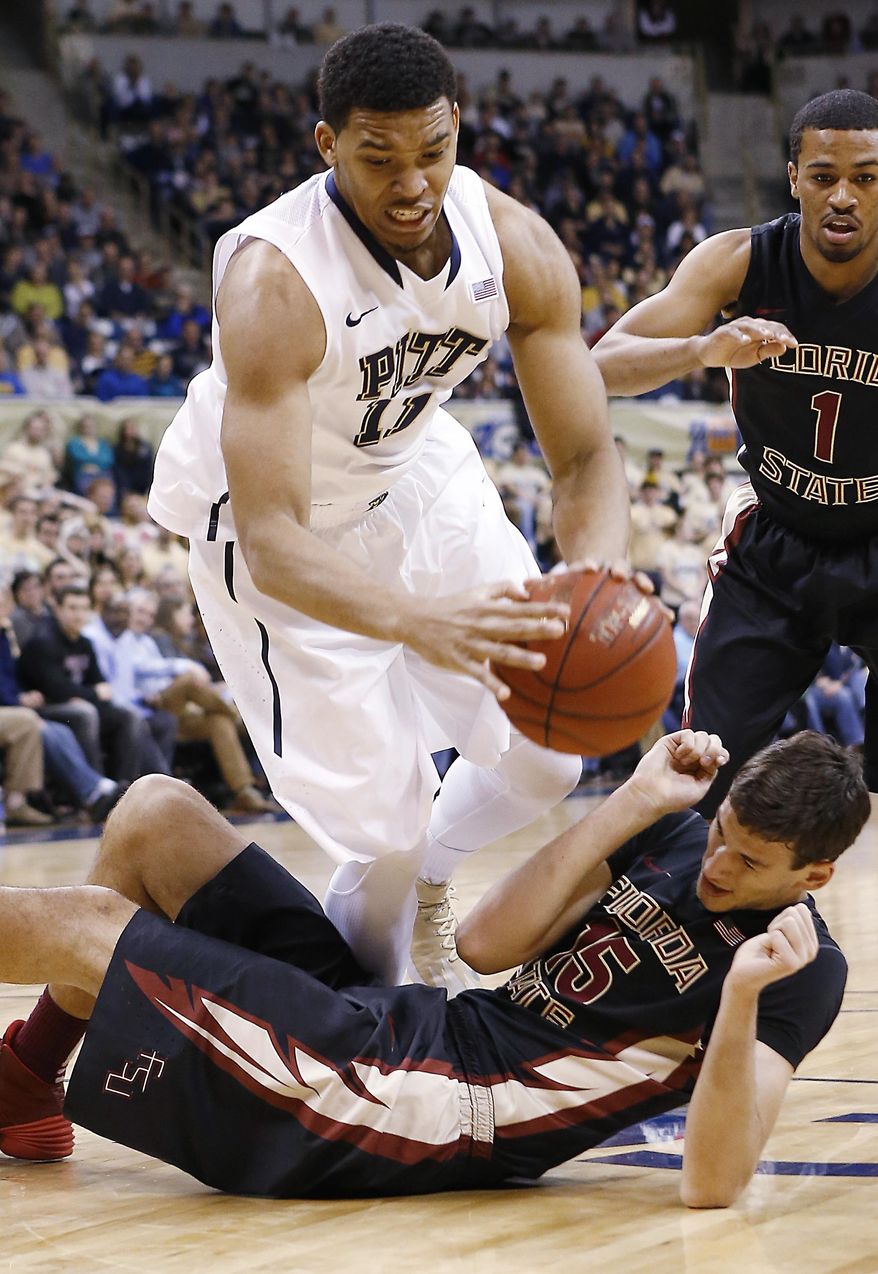 Pittsburgh's Derrick Randall (11) tumbles over Florida State's Boris Bojanovsky (15) as he grabs a loose ball during the first half of an NCAA college basketball game, Sunday, Feb. 23, 2014, in Pittsburgh. (AP Photo/Keith Srakocic)