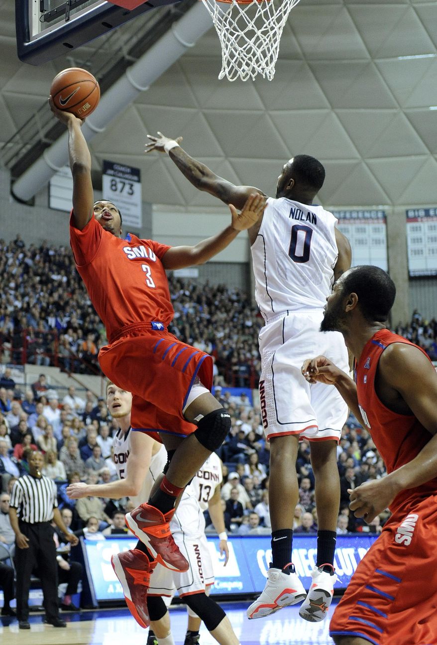 SMU's Sterling Brown (3) shoots over Connecticut's Phillip Nolan during the first half of an NCAA college basketball game in Storrs, Conn., Sunday, Feb. 23, 2014. (AP Photo/Fred Beckham)