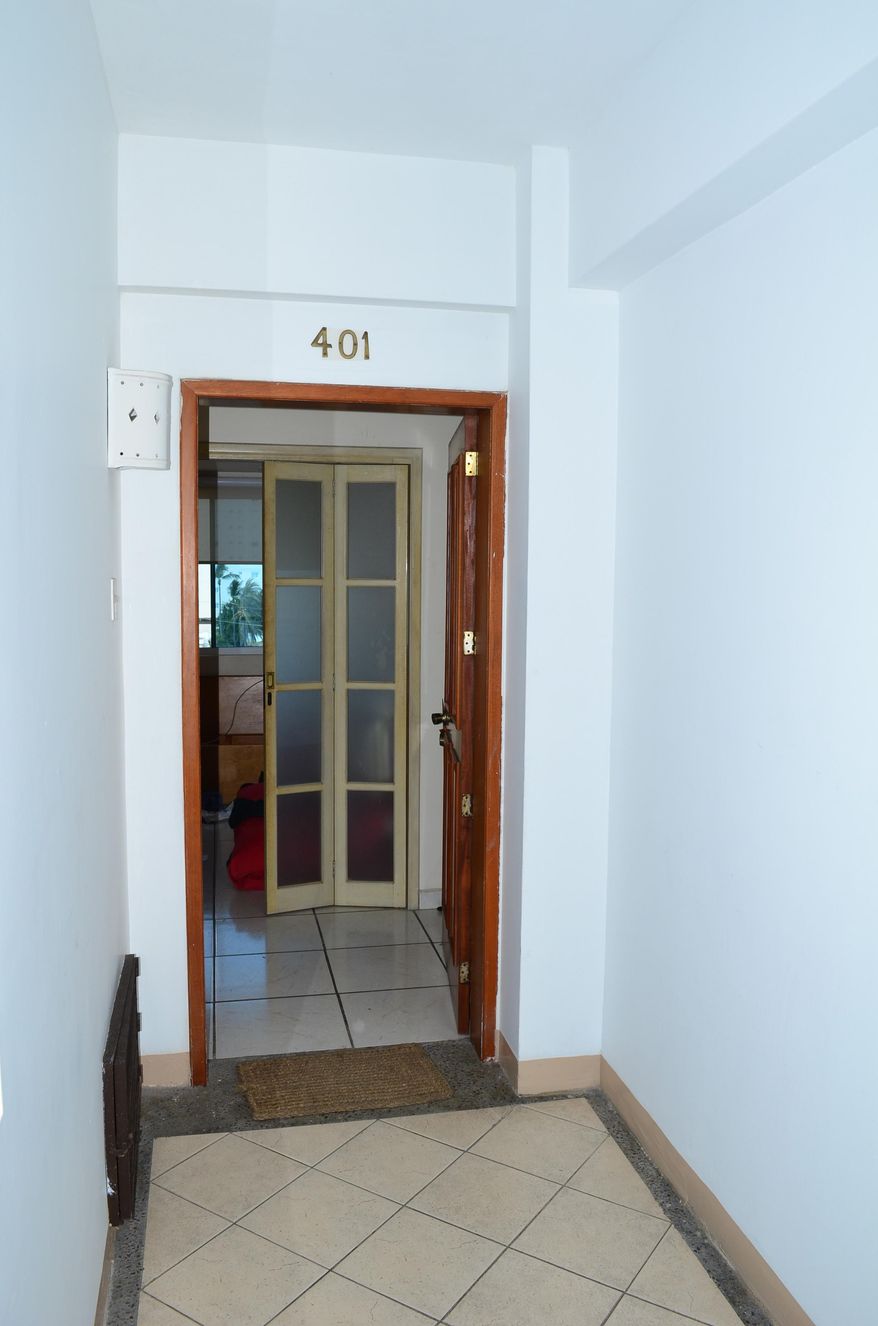 A door remains open at the entrance to the high-rise condominium where famed drug boss Joaquin Guzman Loera "El Chapo" was arrested, in Mazatlan, Mexico, Saturday Feb. 22, 2014. At the moment of his arrest, Guzman was found with an unidentified woman, said one official not authorized to be quoted by name, adding that the U.S. Drug Enforcement Administration and the Marshals Service were "heavily involved" in the capture. No shots were fired. (AP Photo/El Debate de Mazatlan) MEXICO OUT, NO PUBLICAR EN MEXICO