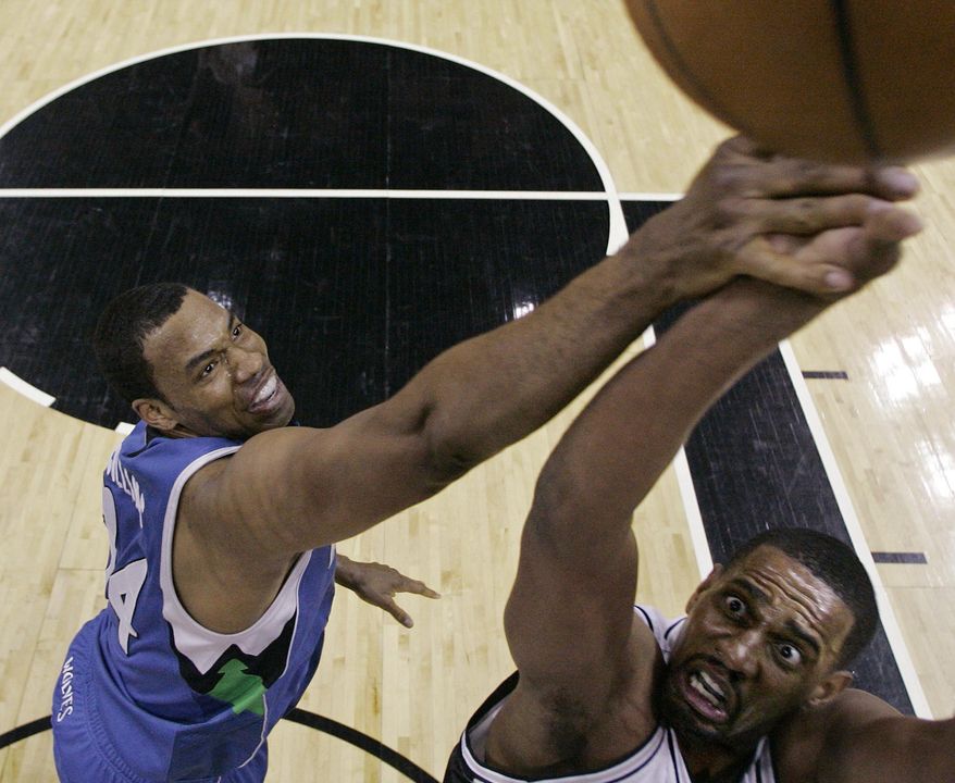 FILE - In a March 17, 2009, file photo Minnesota Timberwolves center Jason Collins, left, defends San Antonio Spurs center Kurt Thomas during the first quarter of an NBA basketball game in San Antonio. A person familiar with the situation says Jason Collins and the Brooklyn Nets are meeting in California and he could sign with the team on Sunday Feb. 23, 2014.   (AP Photo/Eric Gay, file)