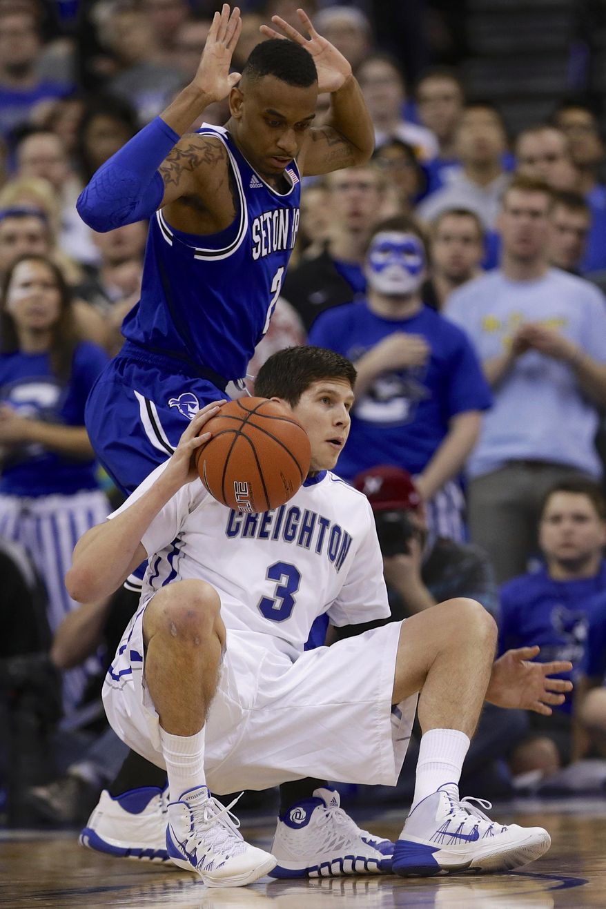 Creighton's Doug McDermott (3) falls down in front of Seton Hall's Brandon Mobley (2) in the first half of an NCAA college basketball game in Omaha, Neb., Sunday, Feb. 23, 2014. (AP Photo/Nati Harnik)