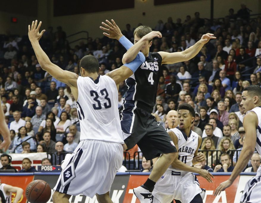 Gonzaga guard Kevin Pangos loses the bal as he gets hooked up with San Diego forward Jito Kok during the second half of a NCAA college basketball game won by San Diego 69-66 Saturday, Feb. 22, 2014, in San Diego. (AP Photo/Lenny Ignelzi)