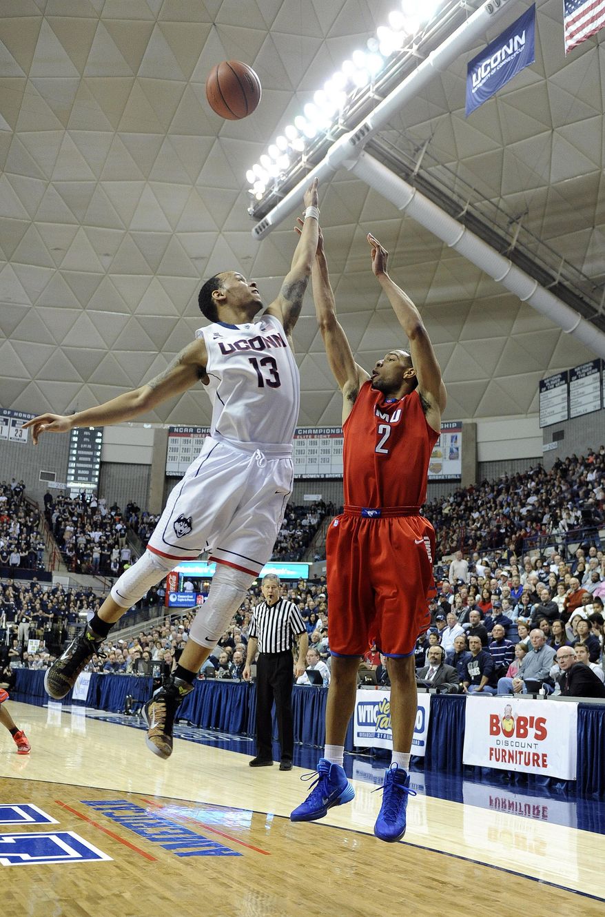 Connecticut's Shabazz Napier (13) guards SMU's Shawn Williams (2) during the first half of an NCAA college basketball game in Storrs, Conn., Sunday, Feb. 23, 2014. (AP Photo/Fred Beckham)